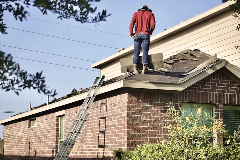 Professional roofer working on a residential roof in Whispering Palms